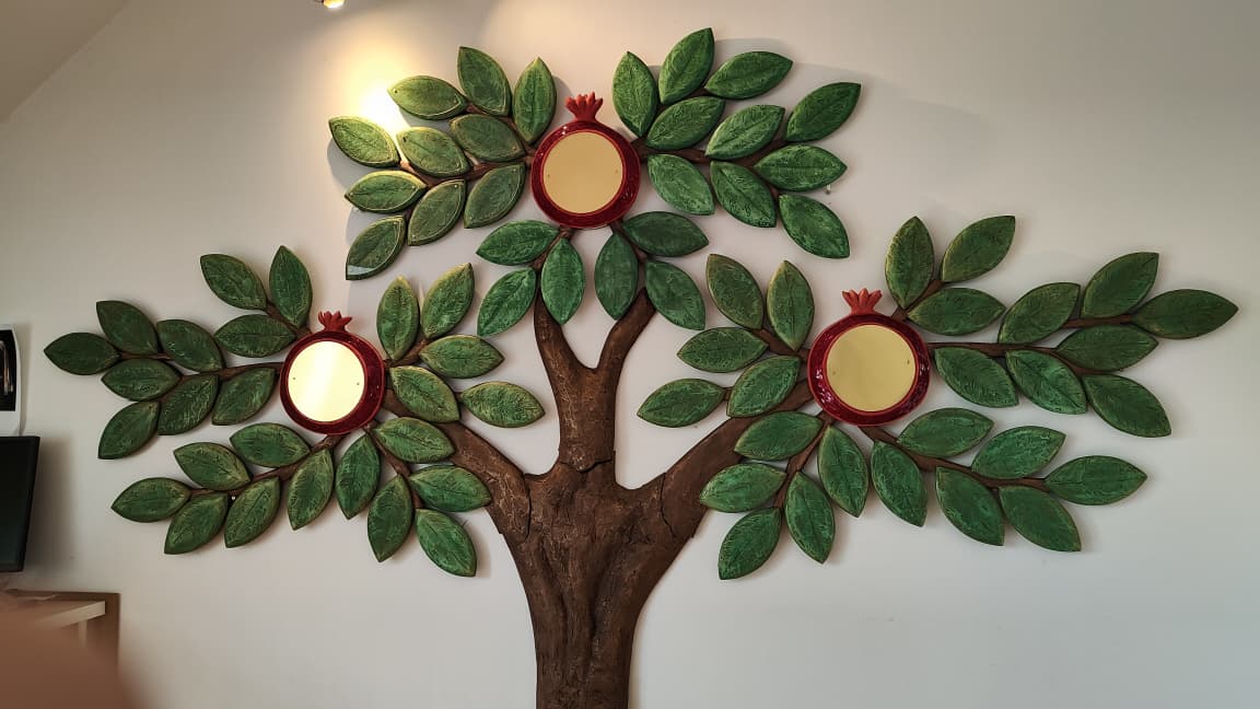 Full view of a handcrafted Tree of Life donor wall sculpture with pomegranate medallions, installed in a synagogue