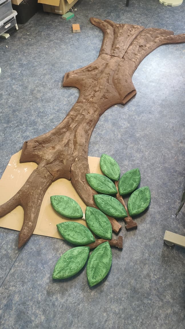 Sculpted tree trunk in bas-relief with hand-textured bark, in fabrication before mounting